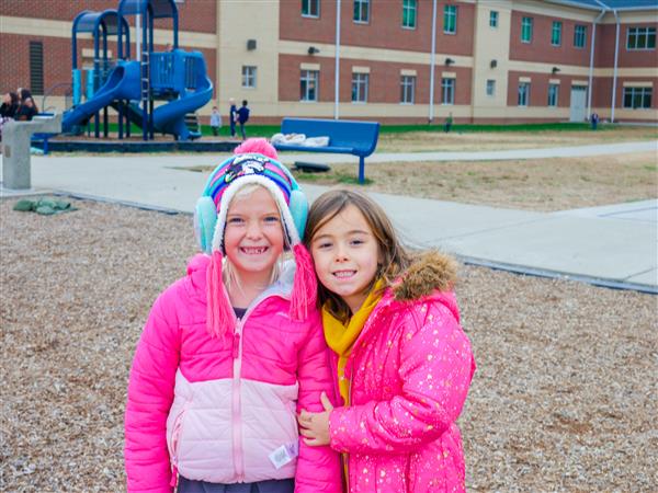two girls in pink jackets